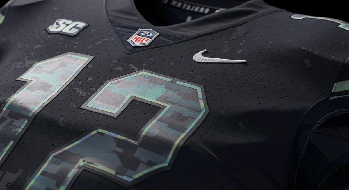 Close-up of a modern college football jersey showcasing innovative fabric and sublimated graphics.