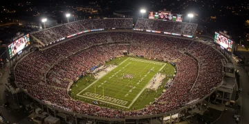 College football stadium packed with fans, showcasing the financial scale of the sport